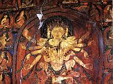 Tibet Guge 08 Tsaparang 03 Yamantaka Temple Guhysamaja-Manjuvajra On the left wall in yab-yum with his consort Sparshavajra are three paintings of the three-faced six-armed Guhyasamaja, Guhyasamaja-Manjuvajra and Guhyasamaja-Akshobyavajra, associated with the Buddha Akshobhya, and the most ancient and fundamental Tantra of Vajrayana tradition of Buddhism. Here is Guhyasamaja-Manjuvajra with his two central hands crossed near the centre of his body, his right hands holding a sword and arrow, and his left holding a lotus and bow. Sparshavajras two main hands circle Guhyasamaja- Manjuvajra, while her other hands mirror his. Photo: Weyer/Aschoff: Tsaparang, Tibets Grosses Geheimnis